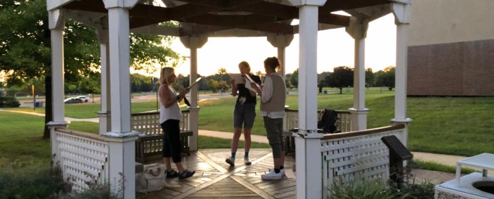 trio rehearsing in the gazebo